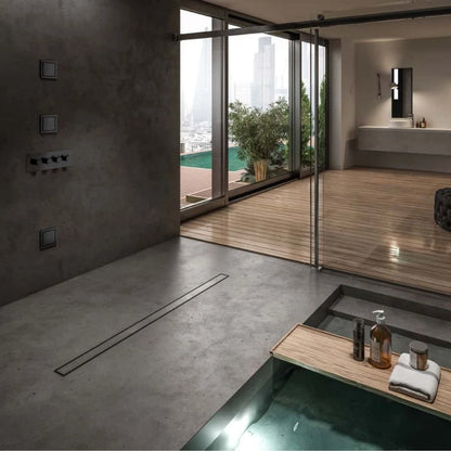 QM Drain ambientación featuring the Mist (Tile-In) Black Linear Drain, showcasing its sleek, minimalist design in a modern shower setup. The image emphasizes the drain's seamless integration with black tiles, ensuring efficient water flow and a clean, contemporary aesthetic for luxury bathroom installations.