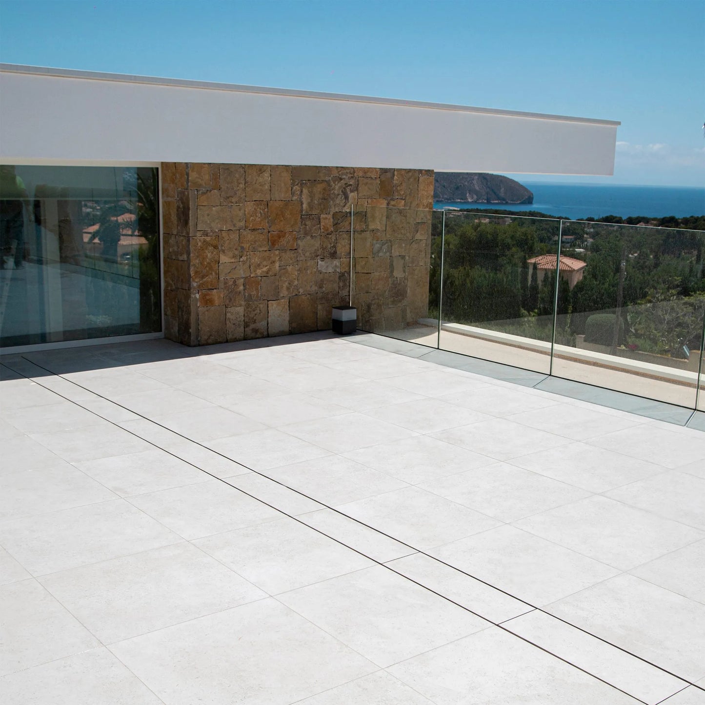 QM Drain Invisible Modular Linear Drain System installed in a deck, providing seamless integration for efficient water drainage. This system is designed for modern outdoor spaces, offering a sleek and minimalist aesthetic while ensuring optimal performance in luxury poolside or patio installations.