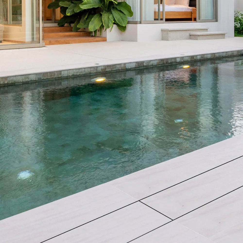 QM Drain Invisible Modular Linear Drain System installed in a deck, providing seamless integration for efficient water drainage. This system is designed for modern outdoor spaces, offering a sleek and minimalist aesthetic while ensuring optimal performance in luxury poolside or patio installations.