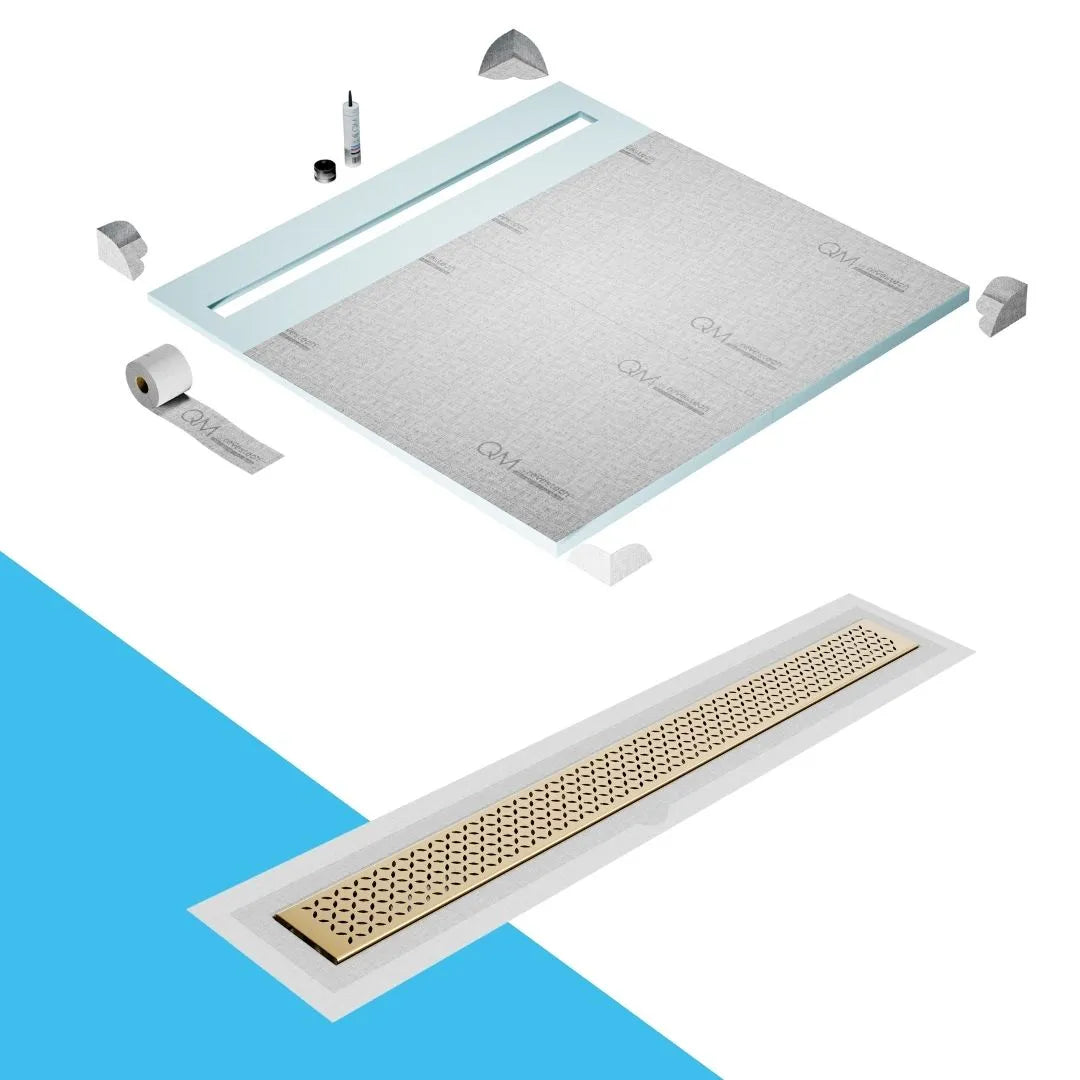 QM Drain Shower Pan with Delmar Lotus Flange Edge Linear Drain, stainless-steel decorative floral grate design, integrated flange for seamless tile installation, efficient drainage, offered in Satin, Gold, Bronze, Polished, and Black finishes.