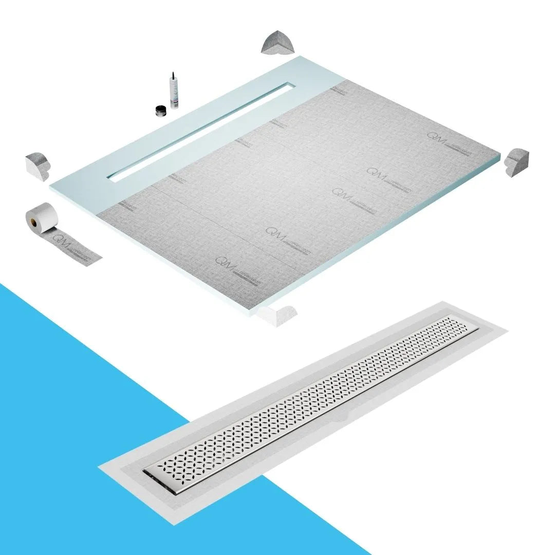 QM Drain Shower Pan with Delmar Lotus Flange Edge Linear Drain, stainless-steel decorative floral grate design, integrated flange for seamless tile installation, efficient drainage, offered in Satin, Gold, Bronze, Polished, and Black finishes.