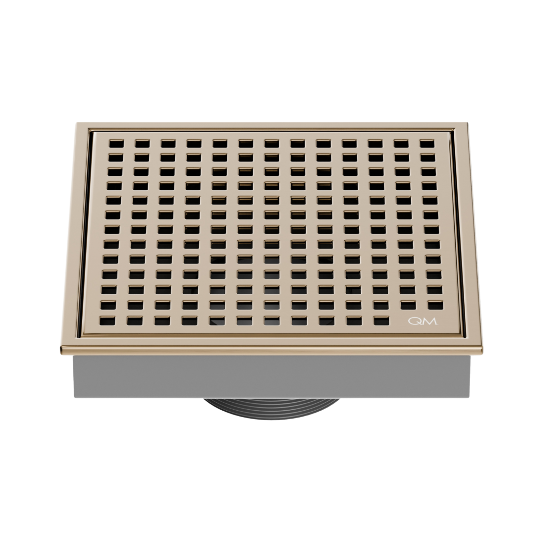 QM Drain Lagos Mira Square Drain 5 3/4 in Champagne finish, featuring a sleek stainless-steel square design with a fine perforated grate. This drain offers efficient water drainage, seamless integration into modern shower floors, and a contemporary aesthetic for luxury bathroom installations.