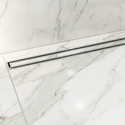 A stunning luxury walk-in shower featuring the QM Drain Lagos Mist Couture adjustable linear drain. The tile-in design creates a seamless floor appearance that integrates perfectly with large-format porcelain tiles for a clean, modern bathroom aesthetic.