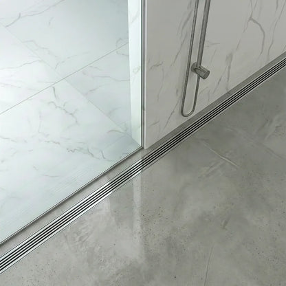 A high-end walk-in shower showcasing the Wedgewire Couture Lagos adjustable linear drain by QM Drain. Its sleek wall-to-wall design and marine-grade stainless steel construction provide a professional drainage solution for modern luxury bathrooms.