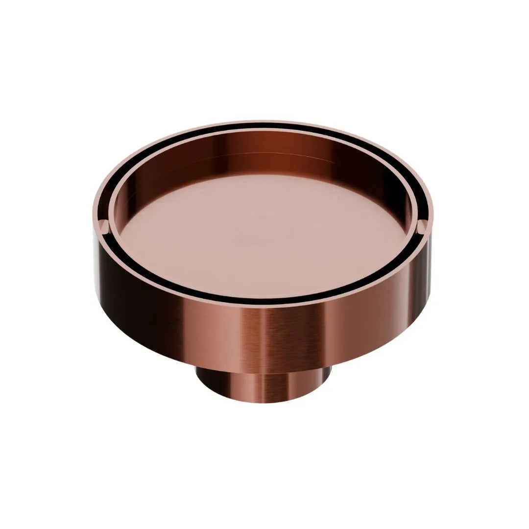 QM Drain Mist Couture Round Drain in Bronze finish, available in 4”x 4” and 5 ¾”x 5 ¾” sizes. This elegant stainless-steel drain features a fine perforated circular grate, providing efficient water drainage while seamlessly integrating into modern luxury shower and bathroom installations.