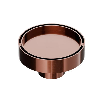 QM Drain Mist Couture Round Drain in Bronze finish, available in 4”x 4” and 5 ¾”x 5 ¾” sizes. This elegant stainless-steel drain features a fine perforated circular grate, providing efficient water drainage while seamlessly integrating into modern luxury shower and bathroom installations.