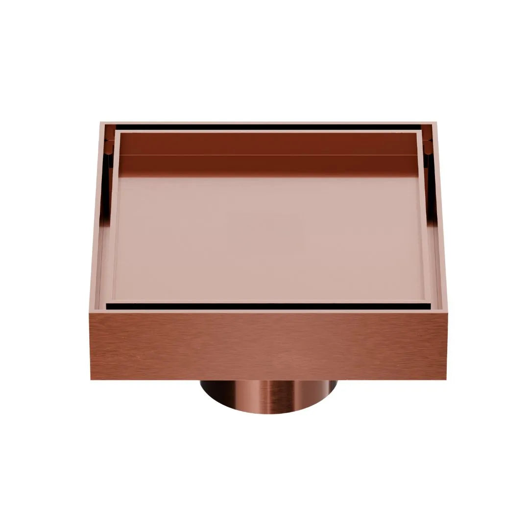 QM Drain Mist Couture Square Drain in Bronze finish, available in 4”x 4” and 5 ¾”x 5 ¾” sizes. This sleek stainless-steel drain features a fine perforated grate for efficient water drainage, offering seamless integration into modern shower floors with a minimalist, luxury aesthetic.