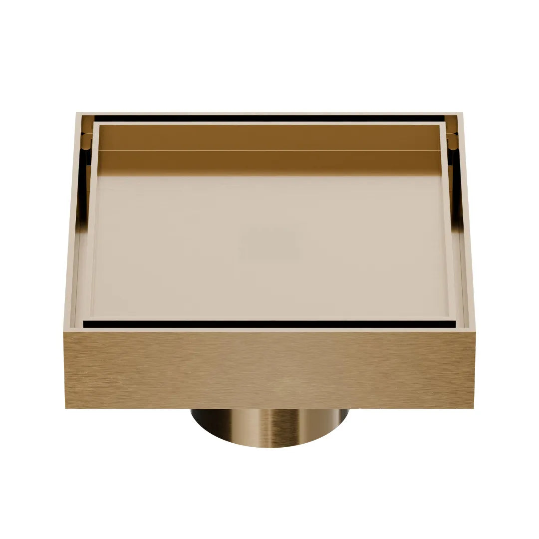 QM Drain Mist Couture Square Drain in Champagne finish, available in 4”x 4” and 5 ¾”x 5 ¾” sizes. This sleek stainless-steel drain features a fine perforated grate for efficient water drainage, offering seamless integration into modern shower floors with a minimalist, luxury aesthetic.