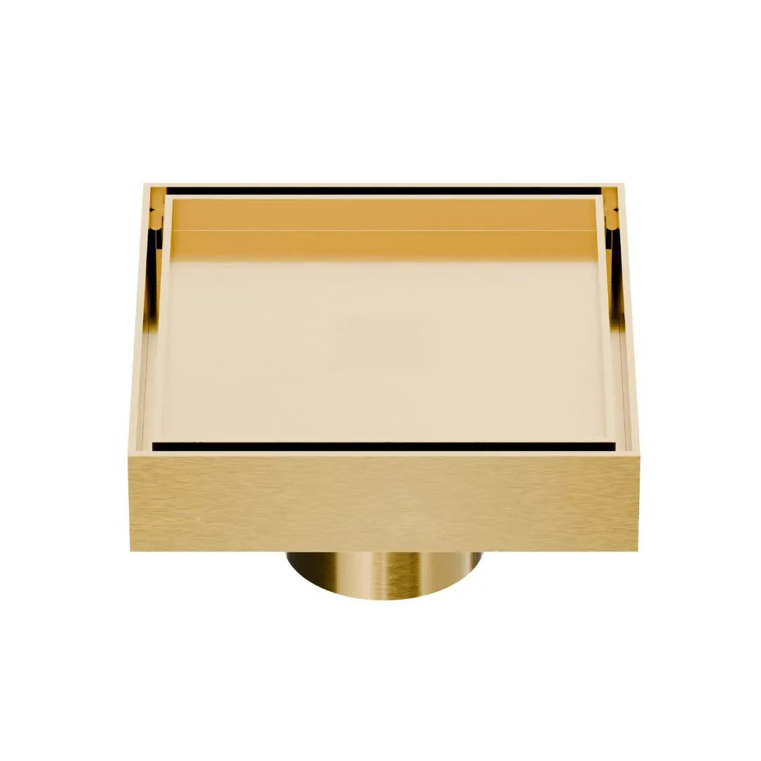 QM Drain Mist Couture Square Drain in Gold finish, available in 4”x 4” and 5 ¾”x 5 ¾” sizes. This sleek stainless-steel drain features a fine perforated grate for efficient water drainage, offering seamless integration into modern shower floors with a minimalist, luxury aesthetic.