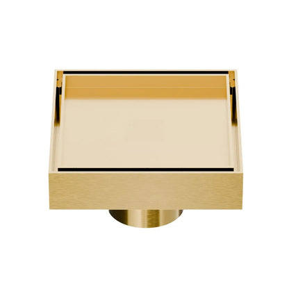 QM Drain Mist Couture Square Drain in Gold finish, available in 4”x 4” and 5 ¾”x 5 ¾” sizes. This sleek stainless-steel drain features a fine perforated grate for efficient water drainage, offering seamless integration into modern shower floors with a minimalist, luxury aesthetic.