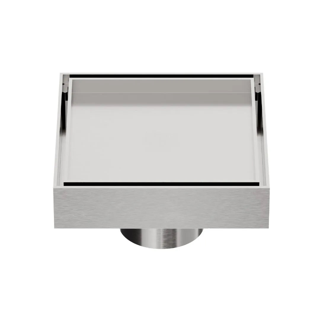 QM Drain Mist Couture Square Drain in Satin finish, available in 4”x 4” and 5 ¾”x 5 ¾” sizes. This sleek stainless-steel drain features a fine perforated grate for efficient water drainage, offering seamless integration into modern shower floors with a minimalist, luxury aesthetic.
