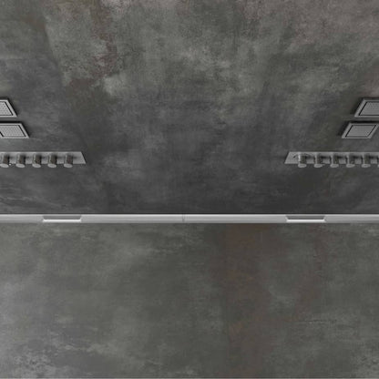 Modern top-down view of the QM Drain Supreme Double-Function Drain in Satin finish—rectangular stainless-steel channel with dual grate patterns, integrated waterproof flange on both sides, and central trap assembly, designed for seamless tile integration and efficient bidirectional water evacuation.