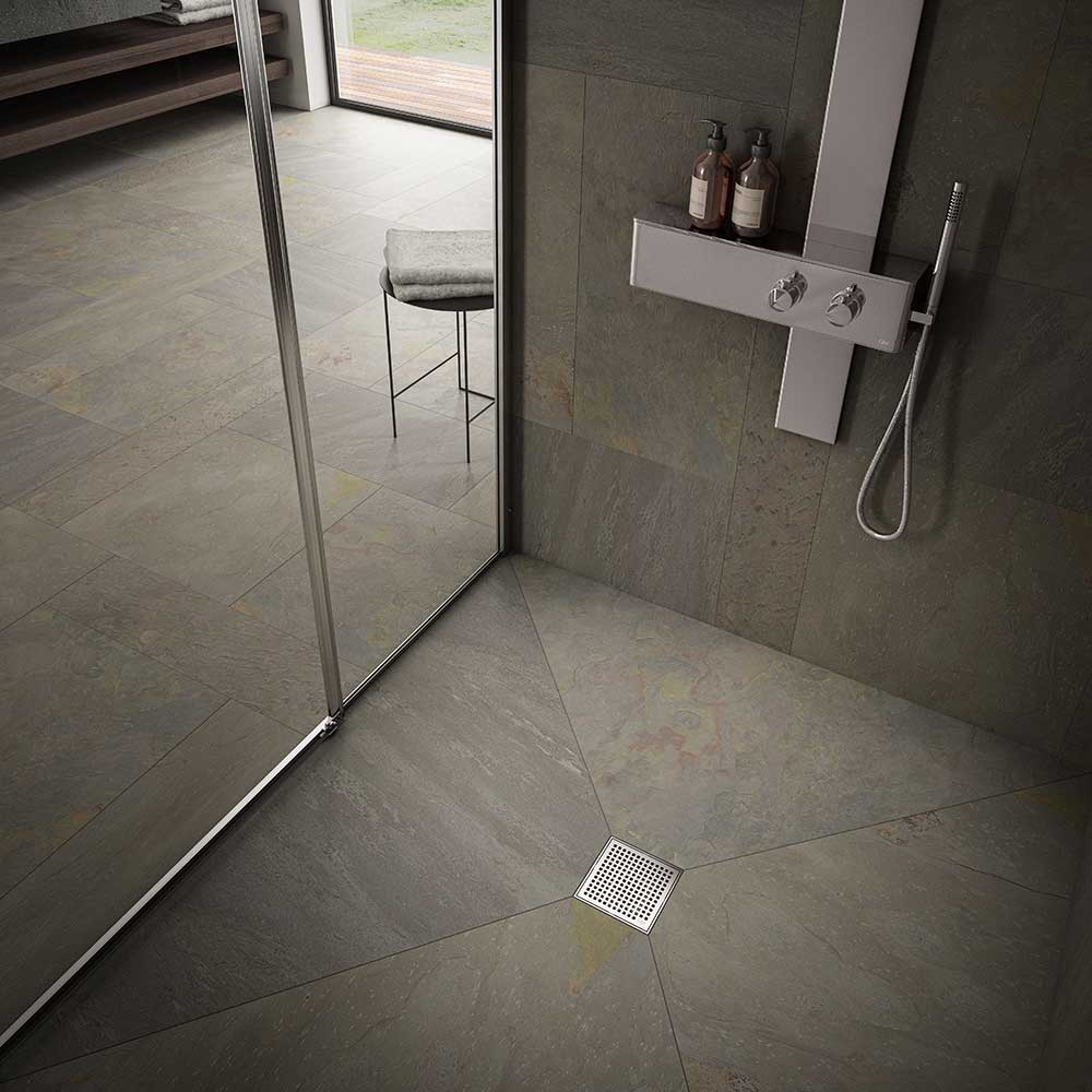 Modern shower floor showcasing the QM Drain Mira Square Drain in Polished finish—4″×4″ stainless-steel tile-insert grate with subtle curved slots, integrated waterproof flange, and efficient high-flow drainage for sleek, contemporary bathroom designs.
