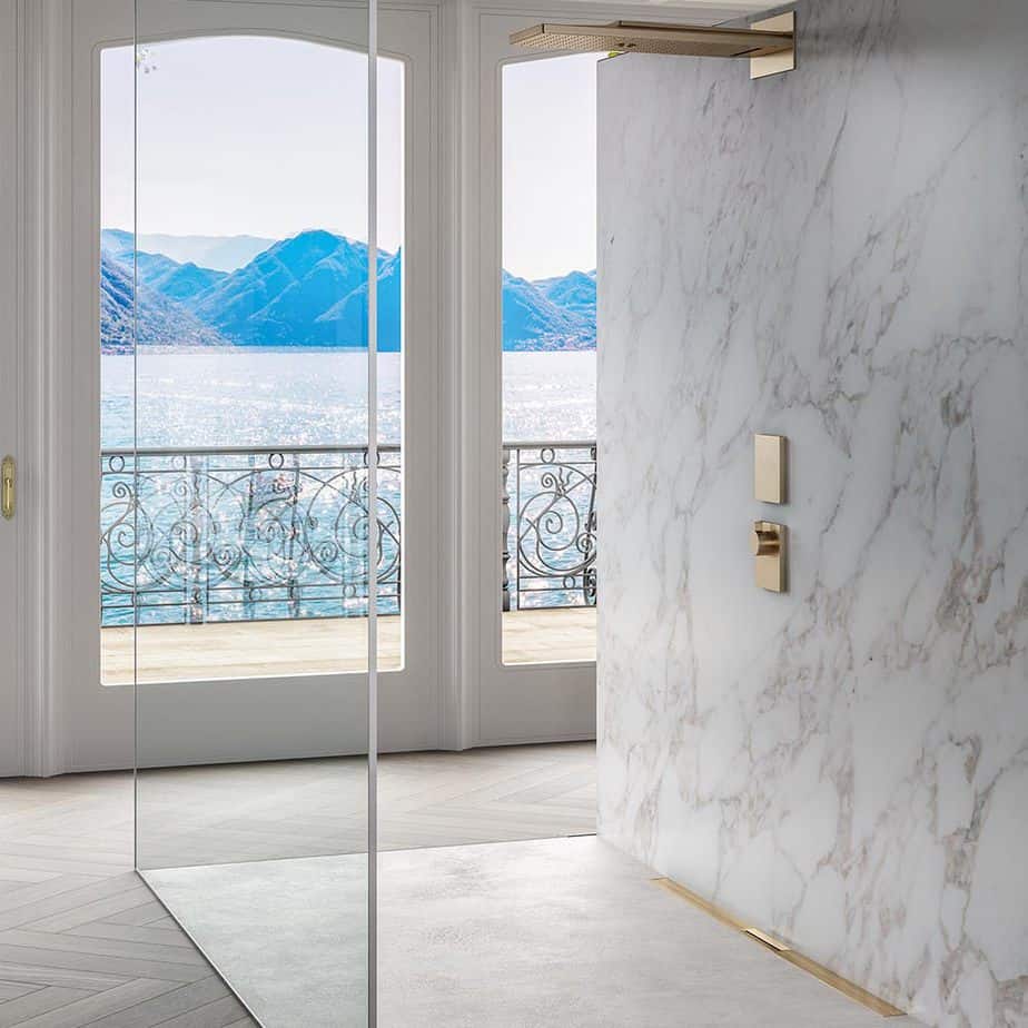 Modern bathroom featuring the QM Drain Supreme Linear Drain in Gold finish—sleek stainless-steel channel installed at shower threshold, showcasing minimalist grate design, integrated waterproof flange, and efficient water evacuation for a luxurious bathing experience.