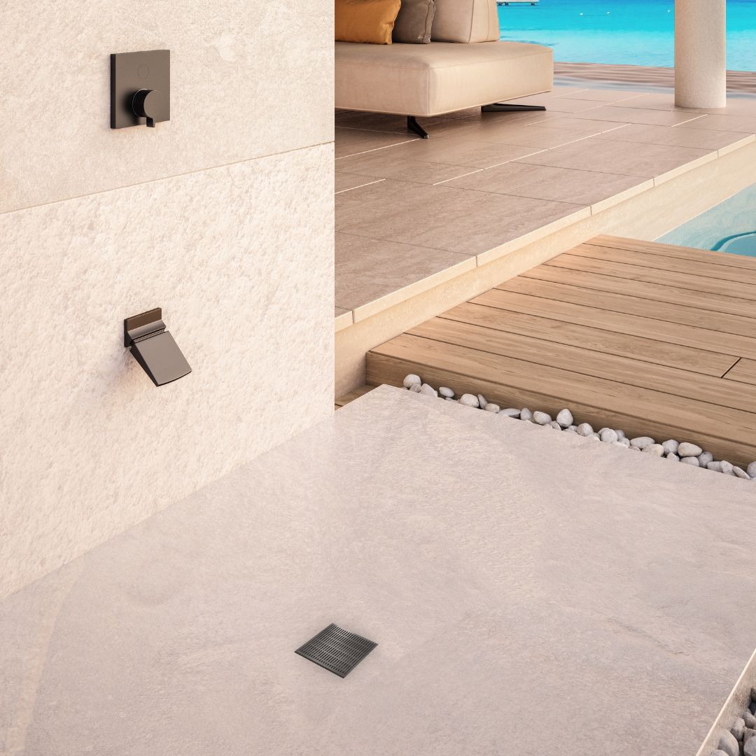 QM Drain Delmar Wedgewire Square Drain in ambient installation, showcasing the modern, sleek design of the stainless-steel wedgewire grate. Available in two sizes, 4x4 and 5 3/4, it ensures efficient water drainage and adds a contemporary aesthetic to high-end shower installations.