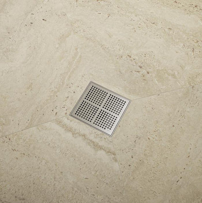QM Drain Delmar Kai Square Drain installed in a modern bathroom setting, featuring a stainless-steel grate with fine square perforations. The image highlights seamless tile integration and efficient water drainage, offering a sleek, minimalist aesthetic perfect for luxury shower and bathroom installations.